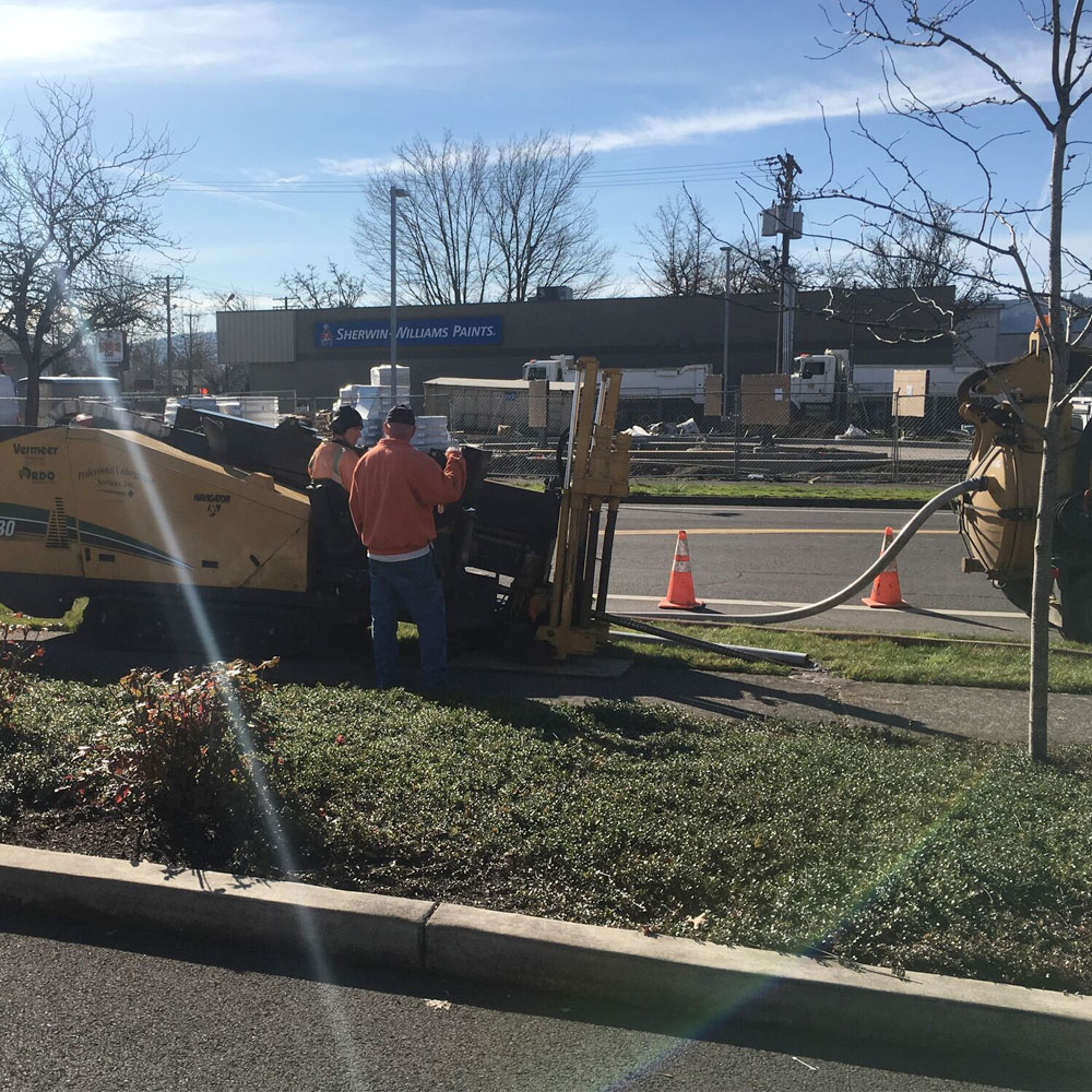 directional drill in action crossing busy intersection traffic control.